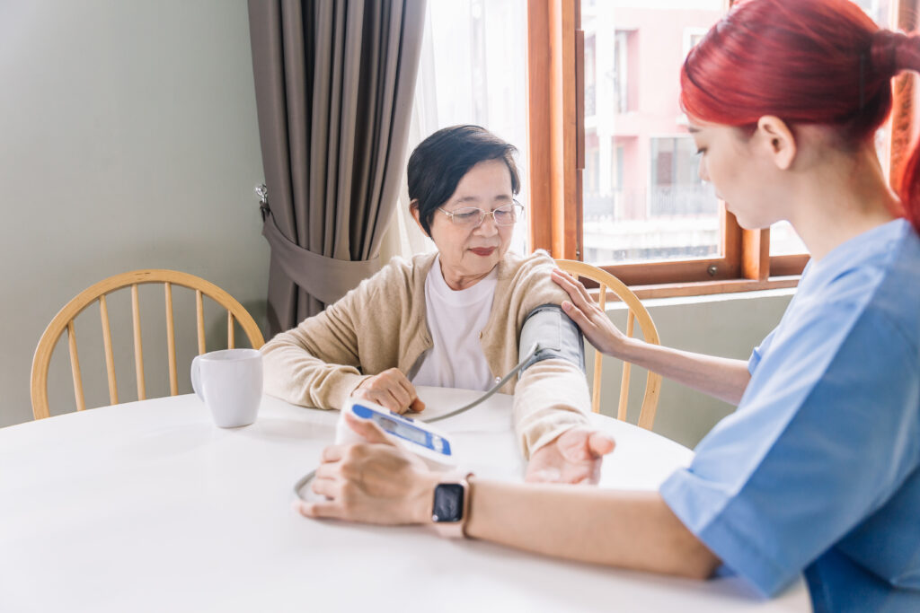 Nurse measuring blood pressure by using automatic blood pressure